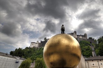 Man on a golden ball