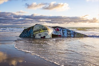 Colorfully painted bunker from the 2nd World War at high tide in the sea