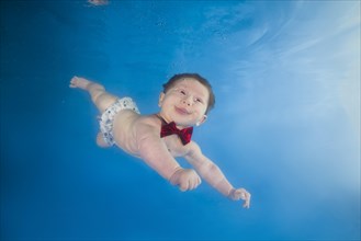 Baby boy diving in the pool