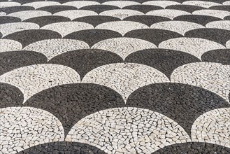 Black and white floor mosaic of cobblestones