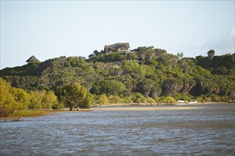 Lodge atop overgrown dune landscape beside Tana River