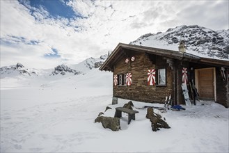 Traditional wooden chalet and snowy winter landscape