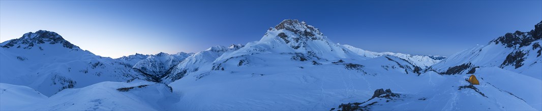 Panorama with tent and view of the mountain Kratzer in winter