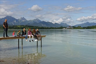 Family sitting on pier