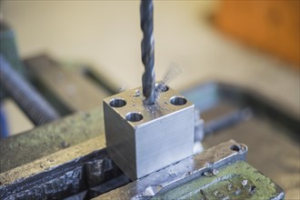 Drilling into a metal workpiece