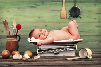 Baby lying on kitchen scales