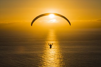 Paraglider over the Atlantic near Puerto Naos during sunset
