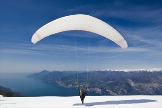 Launch of a paraglider on Monte Baldo above Lake Garda