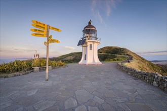 International signpost at the lighthouse at Cape Reinga in evening mood