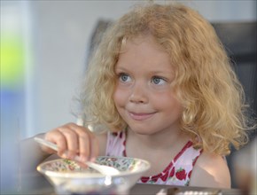 Young girl with blond curly hair