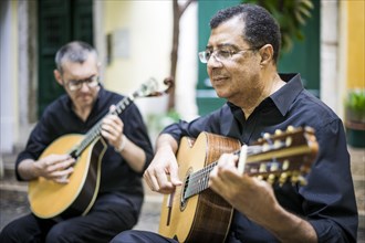 Two fado guitarists with acoustic and portuguese guitars in Alfama