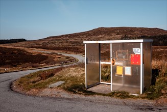 Shelter for hikers with an emergency telephone on the edge of the road A850