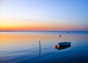 Rowing boat lies in the sea in the evening