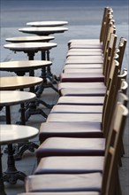 Row of wooden chairs with bistro tables