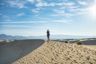 Young man photographing sand dunes