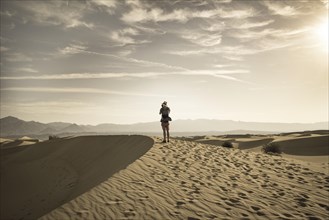 Young man photographing sand dunes