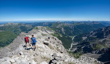 Two hikers descending from the summit of the Hochvogel