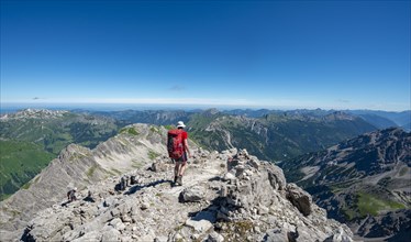 Hiker descending from the summit of the Hochvogel