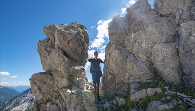 Hiker stands between rocks