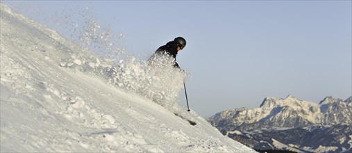 Skier with splashing snow