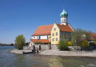 Castle and Church of Saint George on the peninsula in Wasserburg at Lake Constance