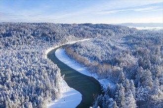 Isar meanders through snow-covered forest area