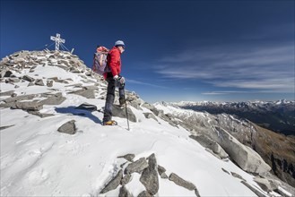 Mountain climber on the summit during the ascent to the Hoher Weisszint