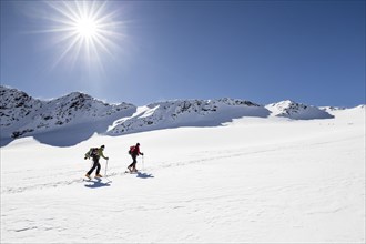 Ski tourers on the ascent to Cima Marmotta in Martell valley