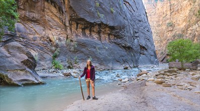 Hiker standing next to river