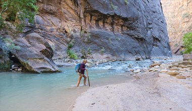 Hiker crossing river