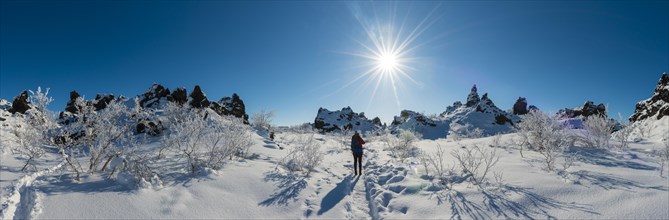 Woman on trail in snowy landscape