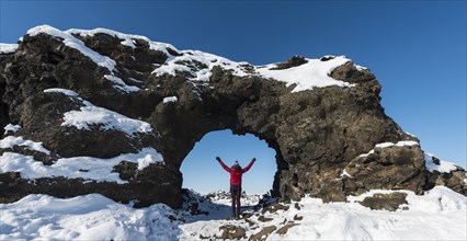 Woman standing in a natural arch