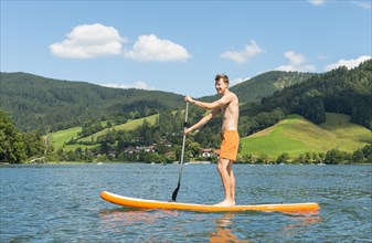 Young man on a paddle board
