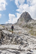 Hiker stands on rocks