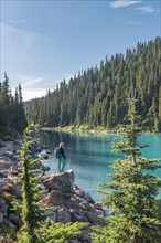 Hiker at the turquoise lake Garibaldi Lake