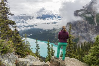 Hiker enjoys views of turquoise glacier lake