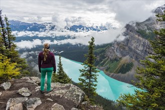 Hiker enjoys views of turquoise glacier lake