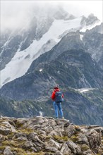 Female hiker off Mt. Shuksan with snow and glacier