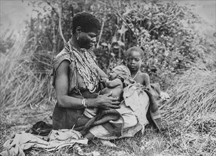 African woman with two children outdoors