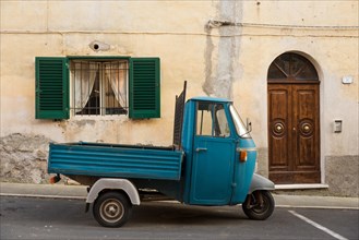 Typical Italian Tricycle Piaggio Ape parked in an alley