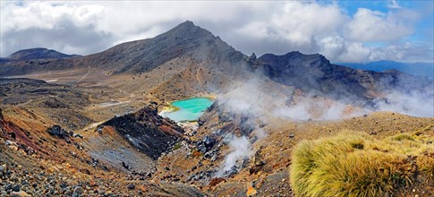 Volcanically active smoky landscape with green Emerald Lakes