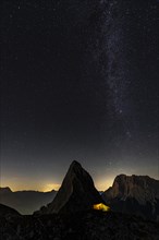 Summit of the Sonnenspitze and tent as well as Zugspitze in the background with starry sky
