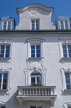 White facade with stucco and balcony