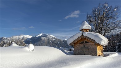 Wooden chapel with snow on Vomperberg