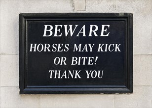 Beware horses may kick or bite sign