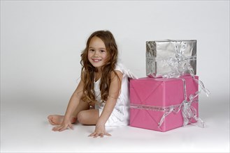 Girl as Christmas angel with presents