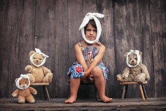 Four-year girl and teddy bears with toothache