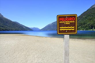 Sandy beach beach with warning sign
