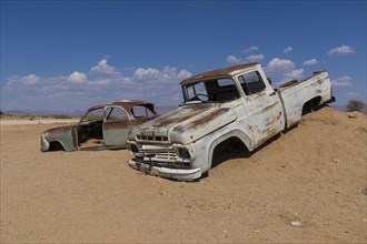 Old car wreck in sand