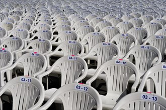 Numbered white plastic chairs